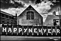 a black and white photo of a happy new year sign