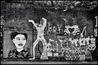 a black and white photo of graffiti on a wall