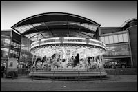 a black and white photo of a carousel