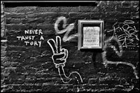 a black and white photo of graffiti on a wall