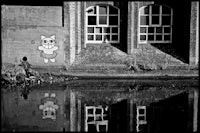 a black and white photo of a building with graffiti on it